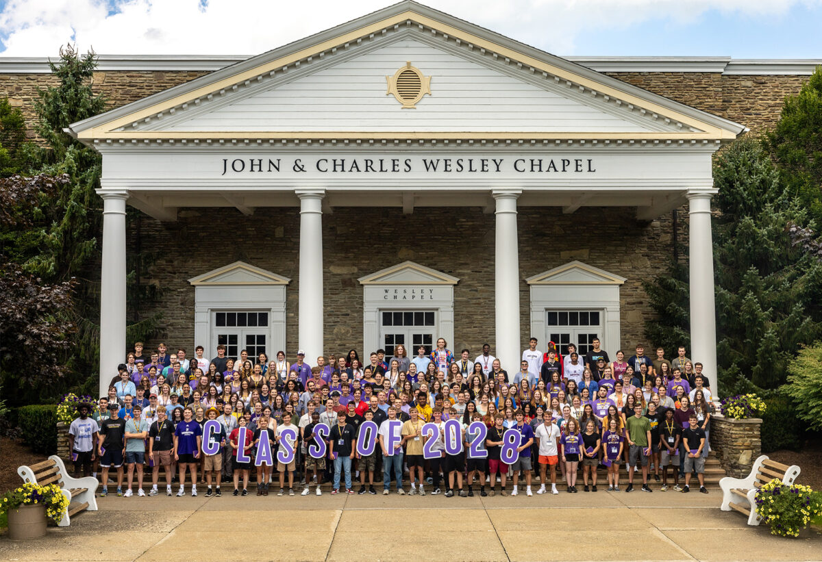 Class of 2028 standing on the Houghton Chapel steps.